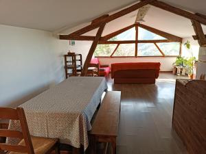 a living room with a table and a couch at Gite du Pic noir in Rivèrenert