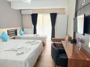 Postel nebo postele na pokoji v ubytování Figen Suite Hotel 2