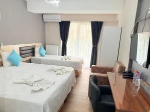 Postel nebo postele na pokoji v ubytování Figen Suite Hotel 2