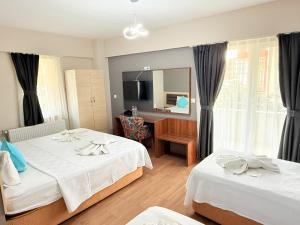 Postel nebo postele na pokoji v ubytování Figen Suite Hotel 2