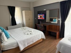 Postel nebo postele na pokoji v ubytování Figen Suite Hotel 2