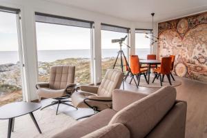 a living room with a view of the ocean at Runde Panorama - Batavia Dream in Terøy