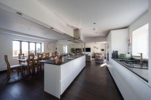a kitchen and dining room with a table and chairs at Woodside Barn Stunning 7 bed Barn conversion in Newmachar