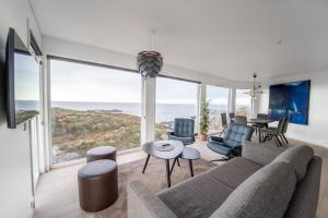a living room with a couch and a table at Runde Panorama - Blått Hav in Terøy