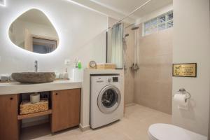 a bathroom with a washing machine and a sink at Theofani's Apartment in Agios Nikolaos +23 photos