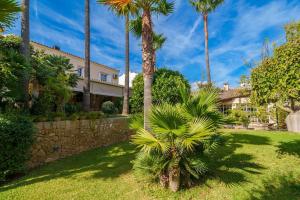 a house with palm trees in front of a yard at C221 CAN MANDOL ETV6207 by Mallorca Villa Selection in Inca