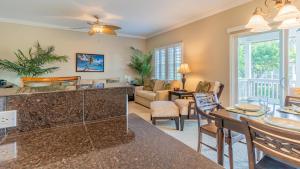 a living room with a couch and a table at Coconut Plantation 1194-3 in Kapolei