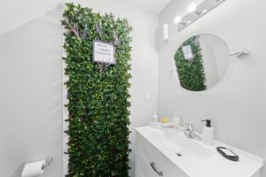 a bathroom with a green wall next to a sink at Private Cozy Room with Free Parking in Toronto +79 photos