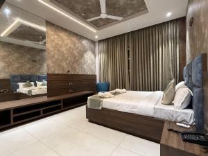 a bedroom with a large bed and a mirror at Golden Heritage Dapoli in Dapoli
