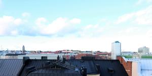 a view of a city from the roofs of buildings at Forenom Serviced Apartments Helsinki Kruununhaka in Helsinki
