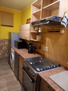 a kitchen with a stove top oven in a kitchen at Apartament-Mieszkanie Gniezno-na doby in Gniezno