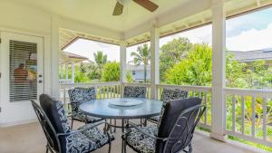 a screened in porch with a table and chairs at Coconut Plantation 1192-4 in Kapolei