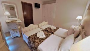Postel nebo postele na pokoji v ubytování Hotel Astron Princess