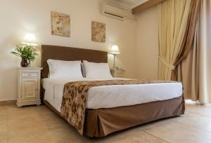 a bedroom with a large bed in a room at Hotel Astron Princess in Karpathos +64 photos