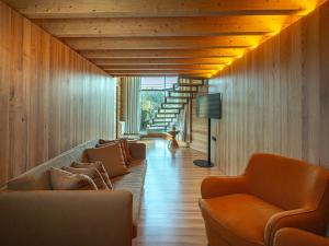 a living room with two couches and a staircase at Lavandeira Douro Nature & Wellness in Baião