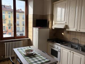 a kitchen with a table and a sink and a window at Casa Caterina in Intra