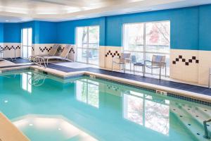 a swimming pool with blue walls and clear water at Sonesta Select Seattle Renton Suites in Renton