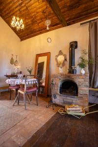 a living room with a table and a fireplace at Chalé Vilarejo - Vila Monte Cunha in Cunha