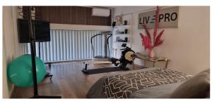 a living room with a bed and a television at LivePro in Larnaca