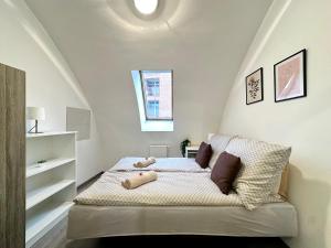 a bedroom with a bed with pillows on it at FREE PARKING - Stargate Budapest in Budapest