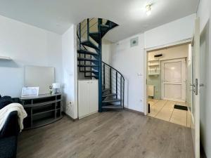 a hallway with a spiral staircase in a apartment at FREE PARKING - Stargate Budapest in Budapest