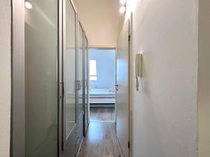 a hallway with a glass door to a bathroom at FREE PARKING - Stargate Budapest in Budapest +26 photos