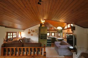 a living room with a large wooden ceiling at Arctic Loft by Ski Alure in Arachova