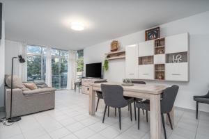 a living room with a dining room table and chairs at Sea Breeze in Portimão