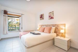 a bedroom with a large bed and a window at Sea Breeze in Portimão