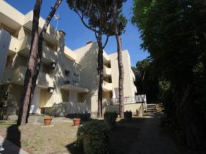 a building with trees in front of it at Modern flat located in Rosolina near the sea in Rosolina Mare