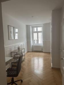 an empty room with a table and a chair in it at The R Apartment Hurbig - Old Town in Schaffhausen