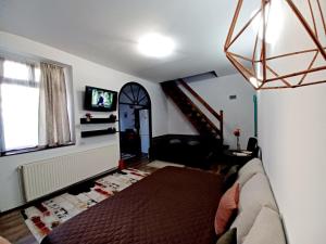 een woonkamer met een bank en een trap bij Lovely Central Apartment in Braşov