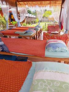 a group of beds in a room with nets at Walden Koh Lanta - Tiny Homes by the Sea in Ko Lanta