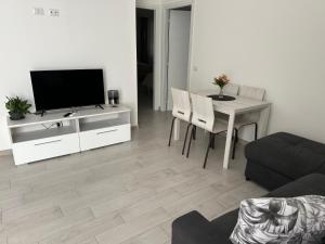 a living room with a television and a table with chairs at Il terrazzino in Ceprano