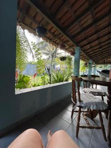 a person laying on a porch with a chair at Apartamento Santa Cruz in Santa Cruz