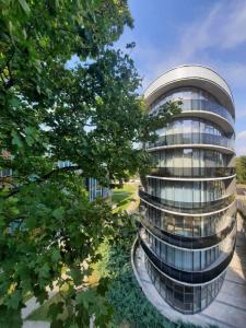 a building with a lot of windows and trees at Home In 2 in Druskininkai
