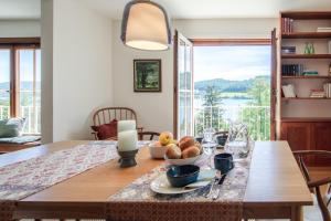 a dining room table with a bowl of fruit on it at Haus am Rebberg in Öhningen