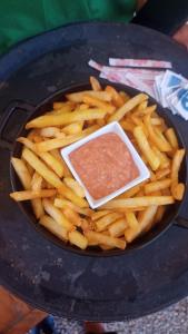 a bowl of french fries with a sauce on it at Pousada in Porto De Galinhas +10 photos