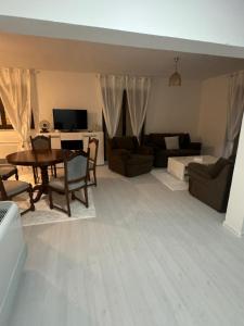 a living room with a table and a couch at Apartment Alisha in Cazin