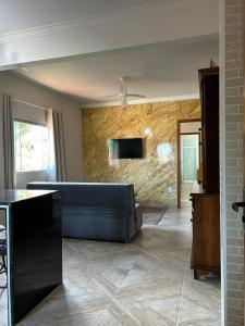 a living room with a couch and a tv on a wall at Apartamento Santa Cruz in Santa Cruz
