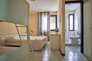 Postel nebo postele na pokoji v ubytování Hotel Mazzurco