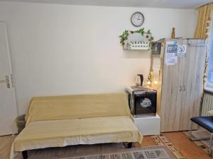 a hospital room with a bed and a clock on the wall at China-Ferienzimmer in Berchtesgaden