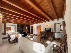 a living room with a couch and a table at Chalet en Pierre 4 P. pour 6 Pers. à Méribel, Navette Gratuite et Grande Terrasse - FR-1-180-583 in Les Allues