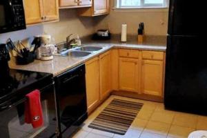 a kitchen with a sink and a stove at Walk to Sanford Stadium DT view Dawg Friendly in Athens