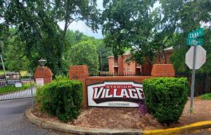 a sign in front of a house with a driveway at Walk to Sanford Stadium DT view Dawg Friendly in Athens
