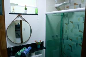a bathroom with a shower and a mirror at Refúgio no Mirante in São Lourenço