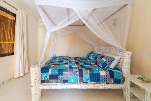 Letto o letti in una camera di The Afters Boutique Hotel Diani
