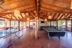 a large room with two ping pong tables in it at Complejo el Paine in Villa General Belgrano