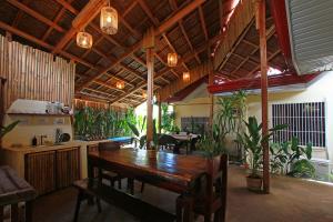 a dining room with a table and some plants at Yellow Banana Siargao in General Luna