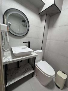 a bathroom with a sink and a toilet and a mirror at Erkhes hotel in Dalandzadgad +8 photos